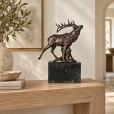 Bugling elk bronze sculpture displayed in an elegant lodge-style interior