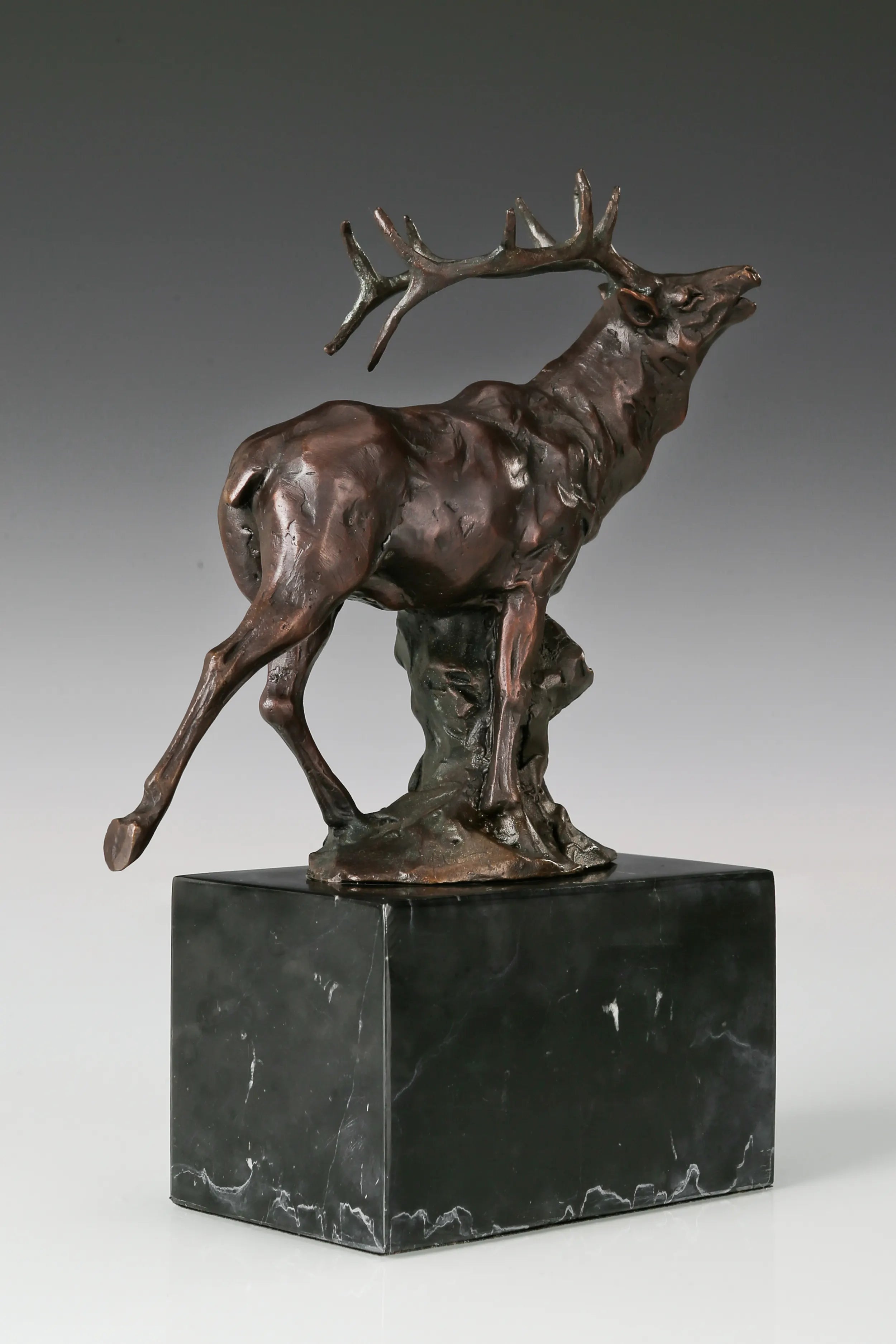Handcrafted bugling elk bronze statue with large branching antlers and marble base, ideal for offices, studies, cabins, lodges and wildlife-inspired interiors.