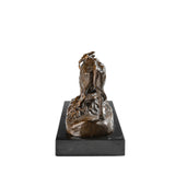 Detailed bronze bullfight scene sculpture with charging bull and matador cape, realistic animal anatomy statue on veined black marble base, loss wax casting fine art.