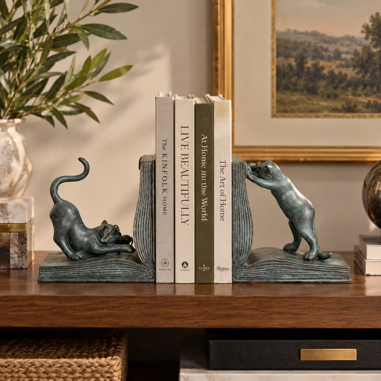 Cat bronze bookends displayed with books on a modern bookshelf