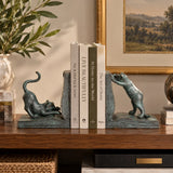 Cat bronze bookends displayed with books on a modern bookshelf
