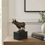 Charging Bull Bronze Sculpture displayed in a styled interior