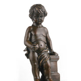 Close-up of putto holding fruit in bronze sculpture