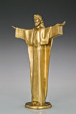 Left side view of Christ the Redeemer bronze statue showing extended arm and flowing robe