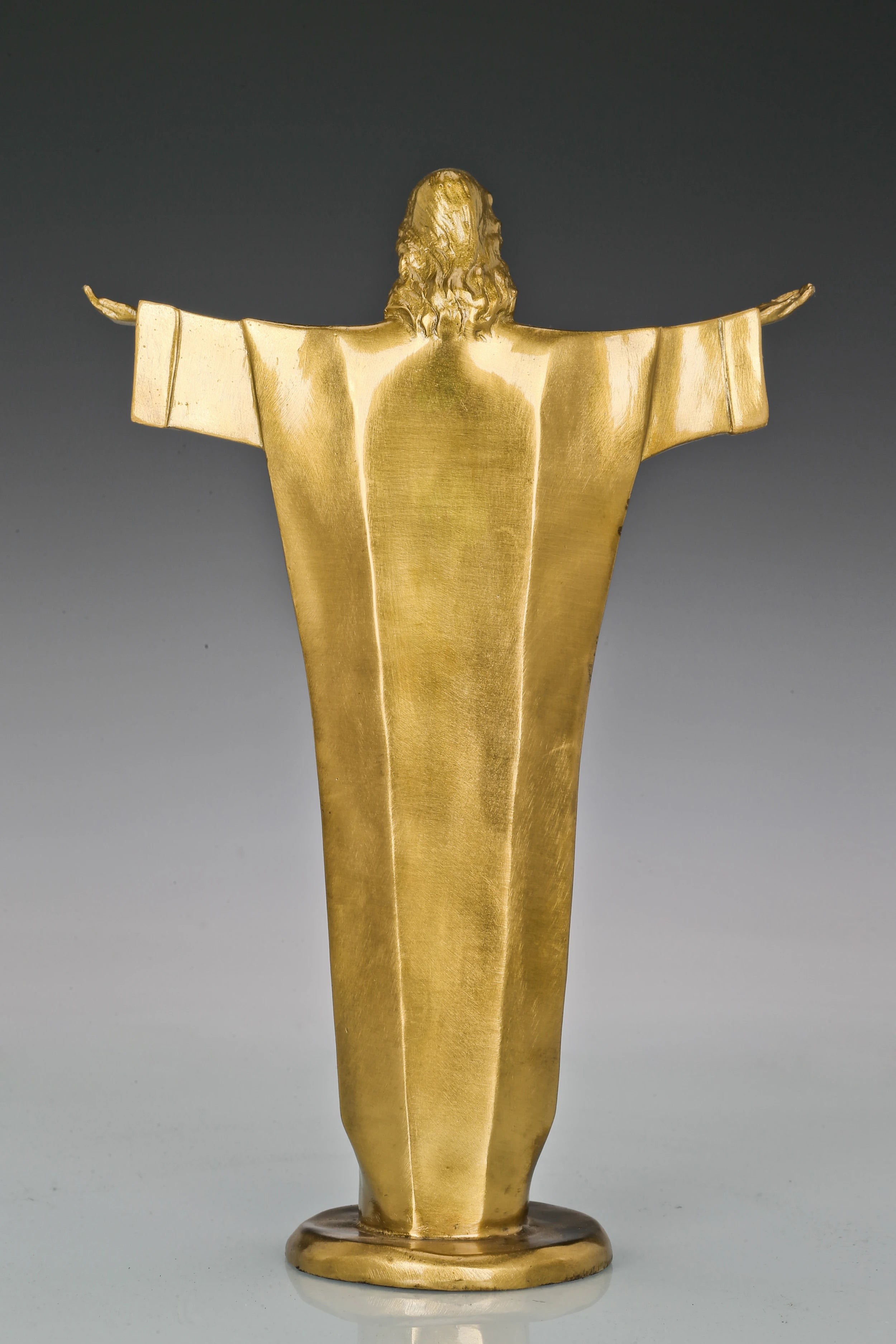 Rear view of Christ the Redeemer bronze sculpture showing the long robe and outstretched arms