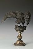 Elegant bronze eagle sculpture with ornate pedestal and detailed feathers. A refined statement piece symbolizing strength, control, and authority.