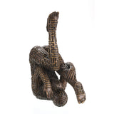 Abstract bronze sculpture of contorted human figure with maze pattern
