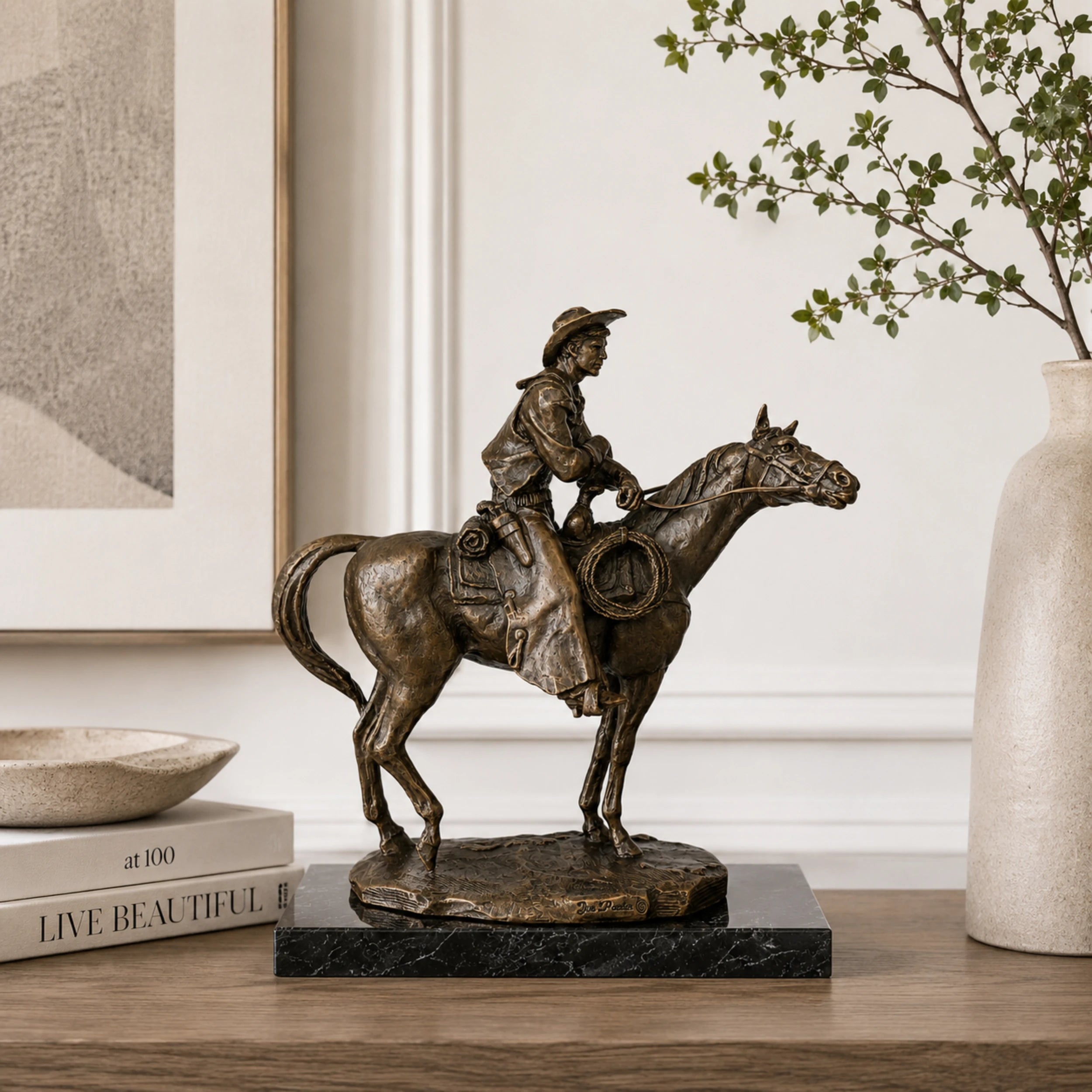 Cowboy on Horse Bronze Sculpture displayed in a styled interior