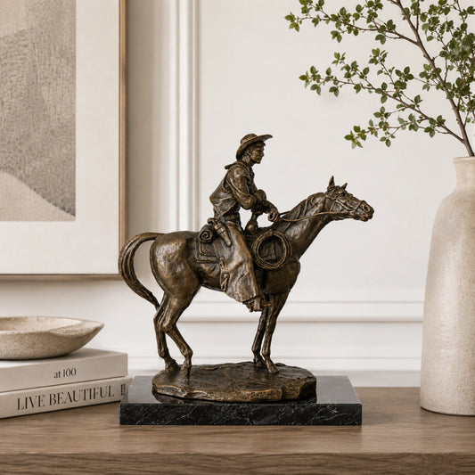 Cowboy on Horse Bronze Sculpture displayed in a styled interior