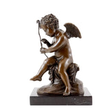 Handcrafted bronze Cupid sculpture seated while repairing his bow with detailed wings