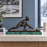 Abstract bronze curler statue with curling stone displayed as modern winter sports and office decor