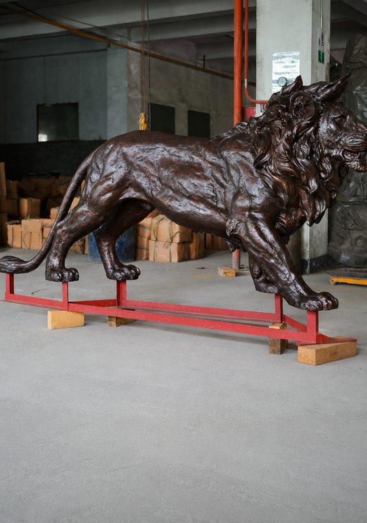 Large custom bronze lion sculpture displayed in the workshop