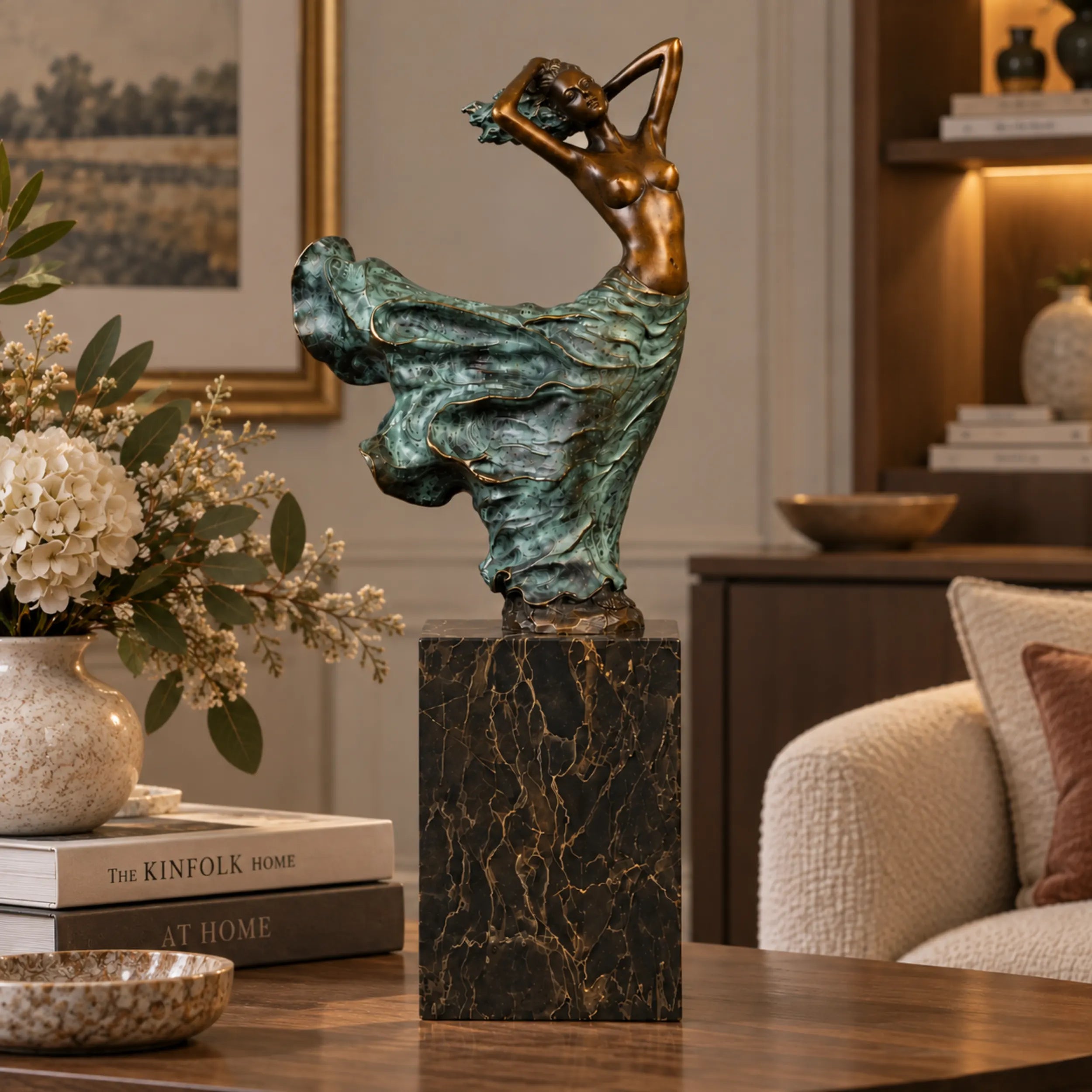 Dancing female bronze sculpture with flowing dress displayed in a modern interior