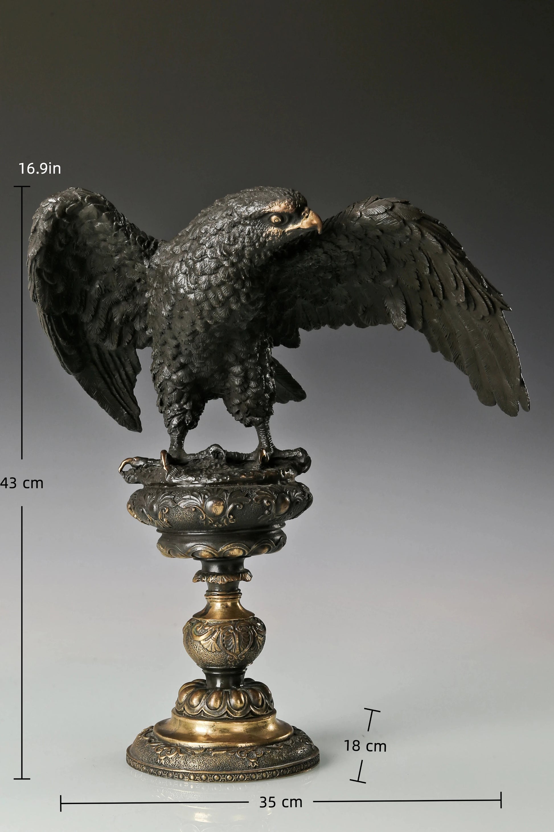 Bronze eagle statue with wings partially spread and decorative base. Classical wildlife sculpture for home decor, office, or collectors.