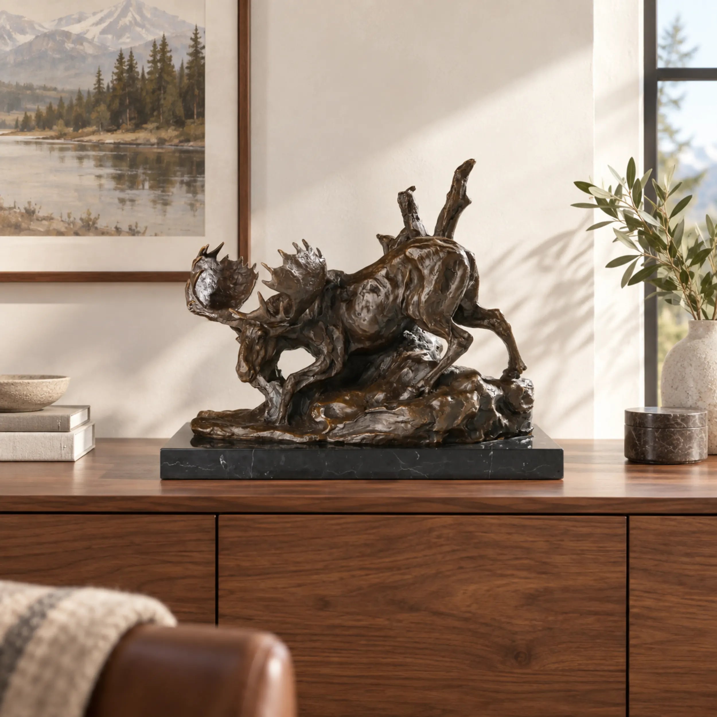 Descending moose bronze sculpture displayed in an elegant lodge interior