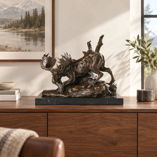 Descending moose bronze sculpture displayed in an elegant lodge interior