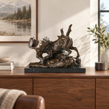 Descending moose bronze sculpture displayed in an elegant lodge interior