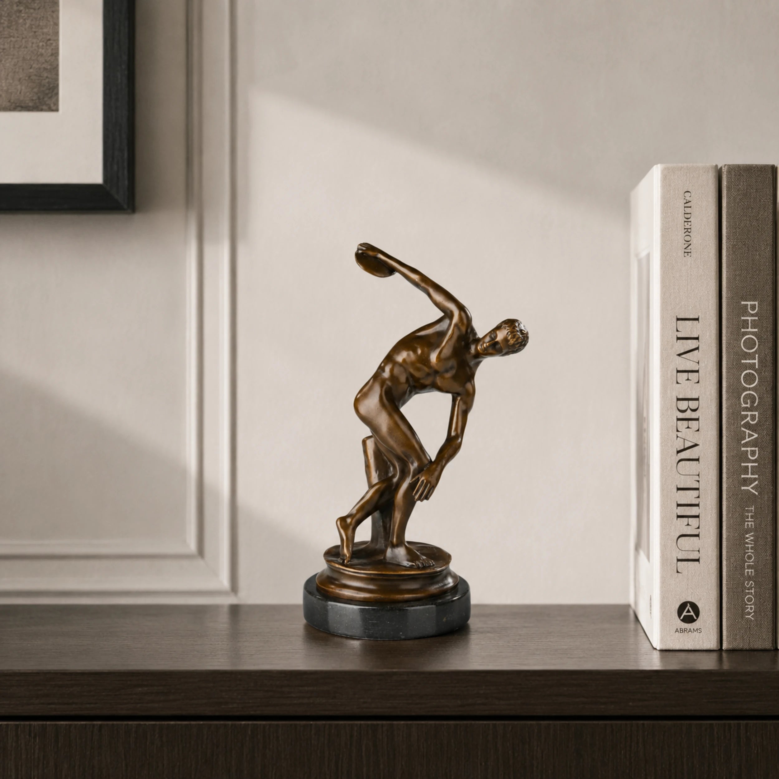 Discus Thrower Bronze Sculpture displayed in a styled interior