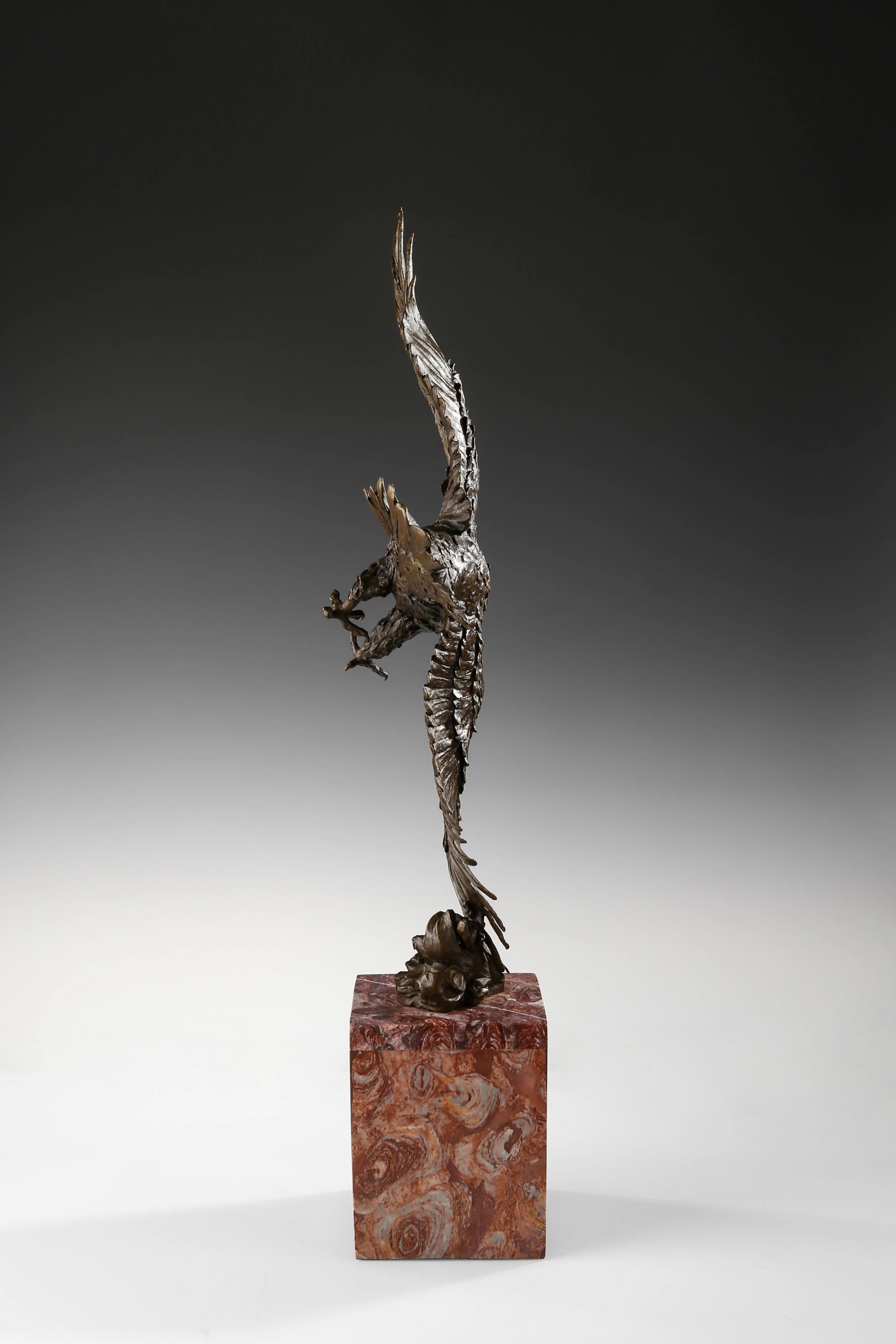 Mythic bronze eagle sculpture diving over waves. A powerful statement piece symbolizing strength, freedom, and mastery of the elements.