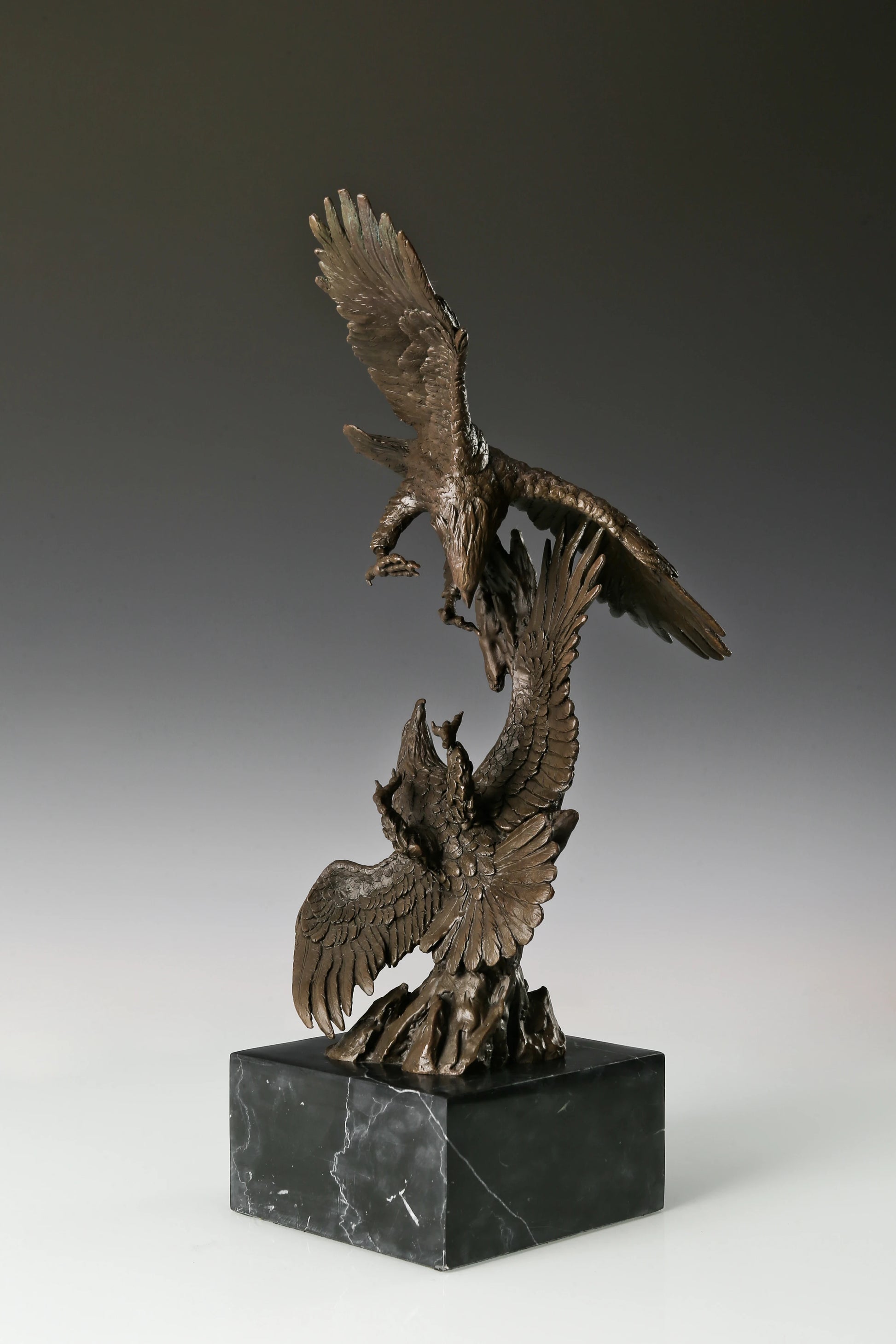 Two eagles bronze sculpture in dynamic interaction pose with detailed feathers and marble base. Elegant decor for home, office, or collectors.