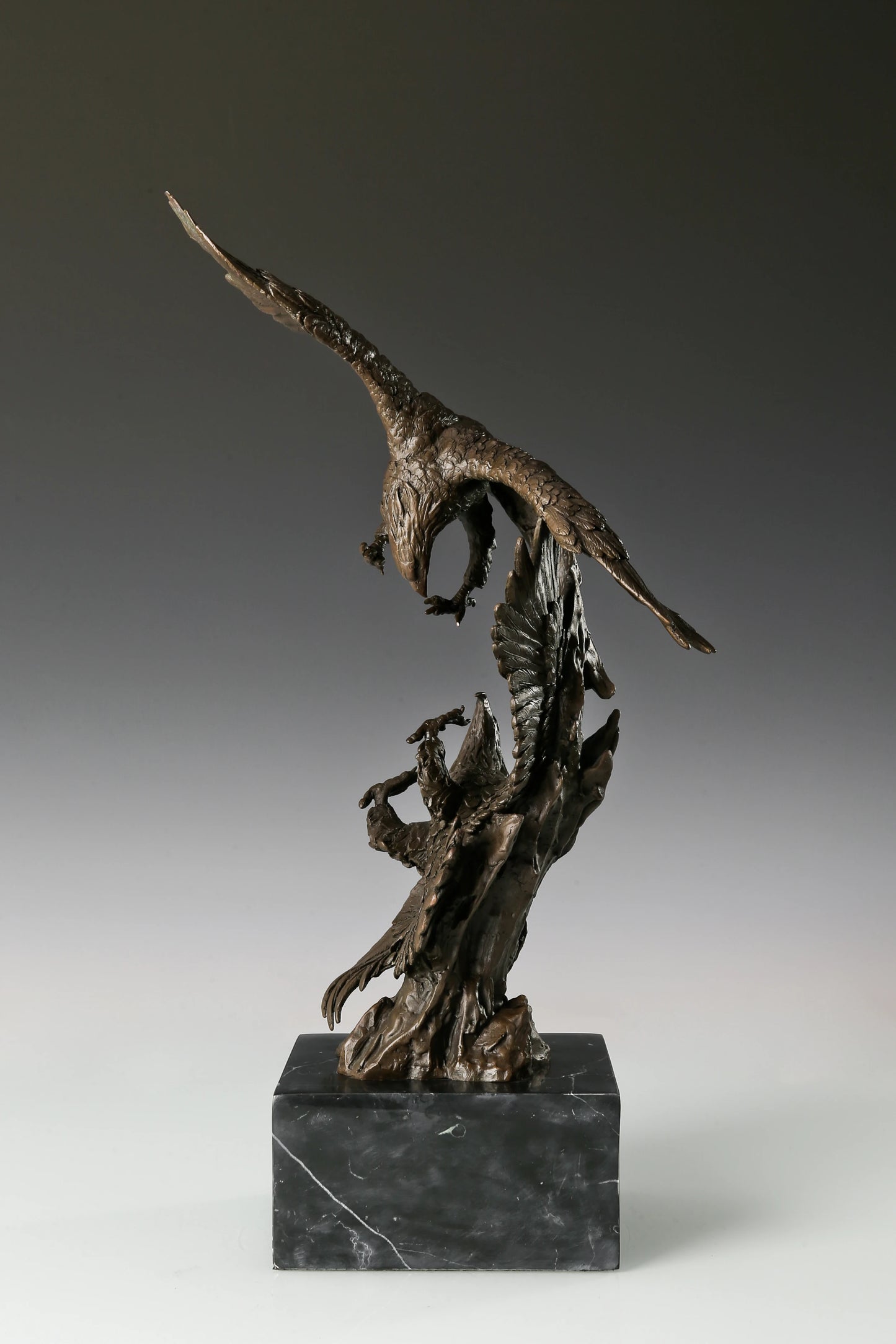 Solid bronze eagles sculpture on black marble base, powerful office decor for law firms and executives.