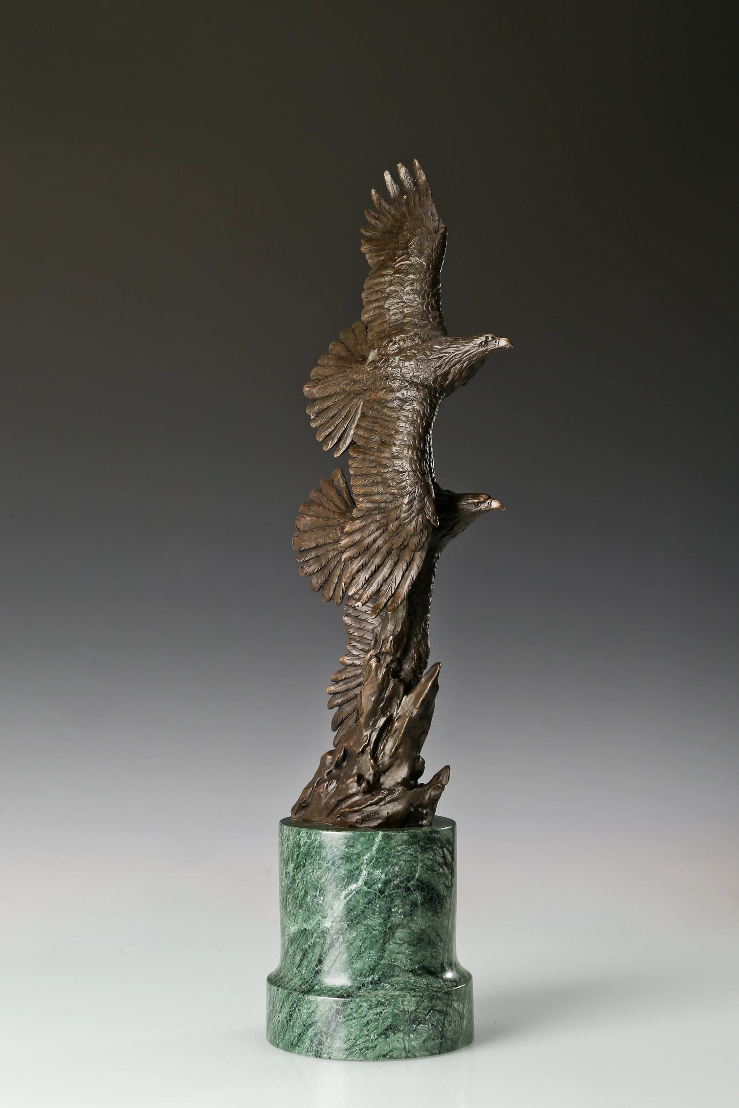 Solid bronze twin eagles soaring statue on green marble base, luxury office desk decor for executives.
