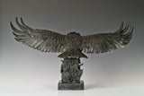 This majestic bronze sculpture portrays a bald eagle in a dramatic moment of motion, capturing the raw intensity of a hunting strike. Crafted using the traditional lost-wax casting method, the sculpture depicts the powerful raptor with its wings fully spread, talons extended forward, and head angled downward in focused pursuit.