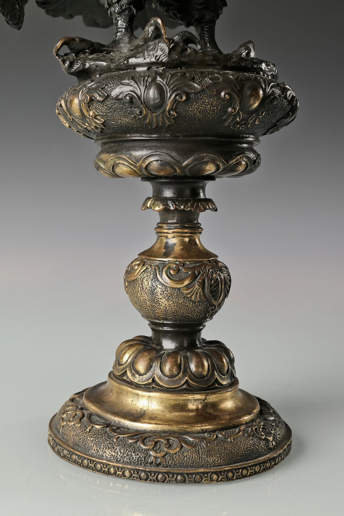 Elegant bronze eagle sculpture with ornate pedestal and detailed feathers. A refined statement piece symbolizing strength, control, and authority.