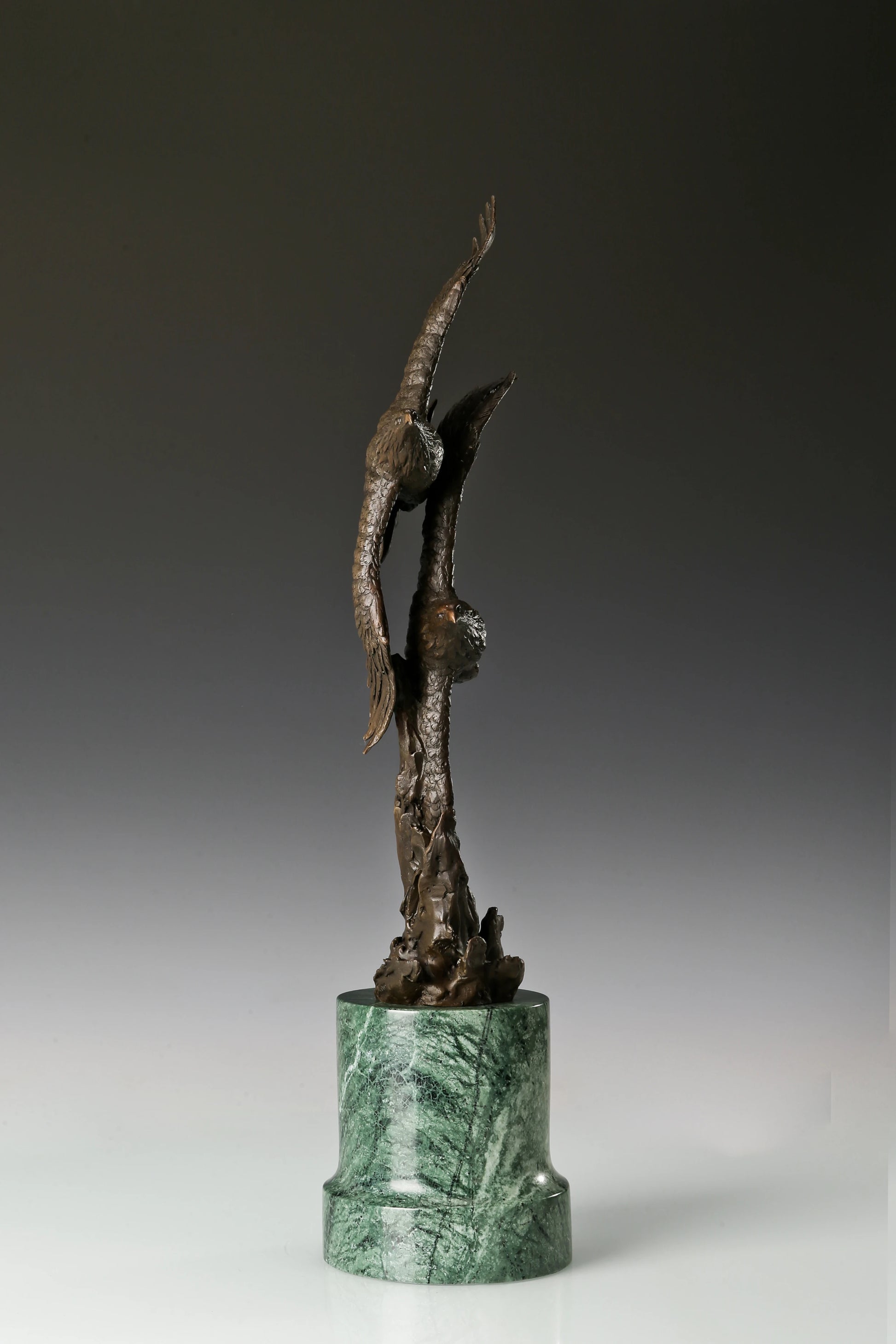 Solid bronze twin eagles soaring statue on green marble base, luxury office desk decor for executives.