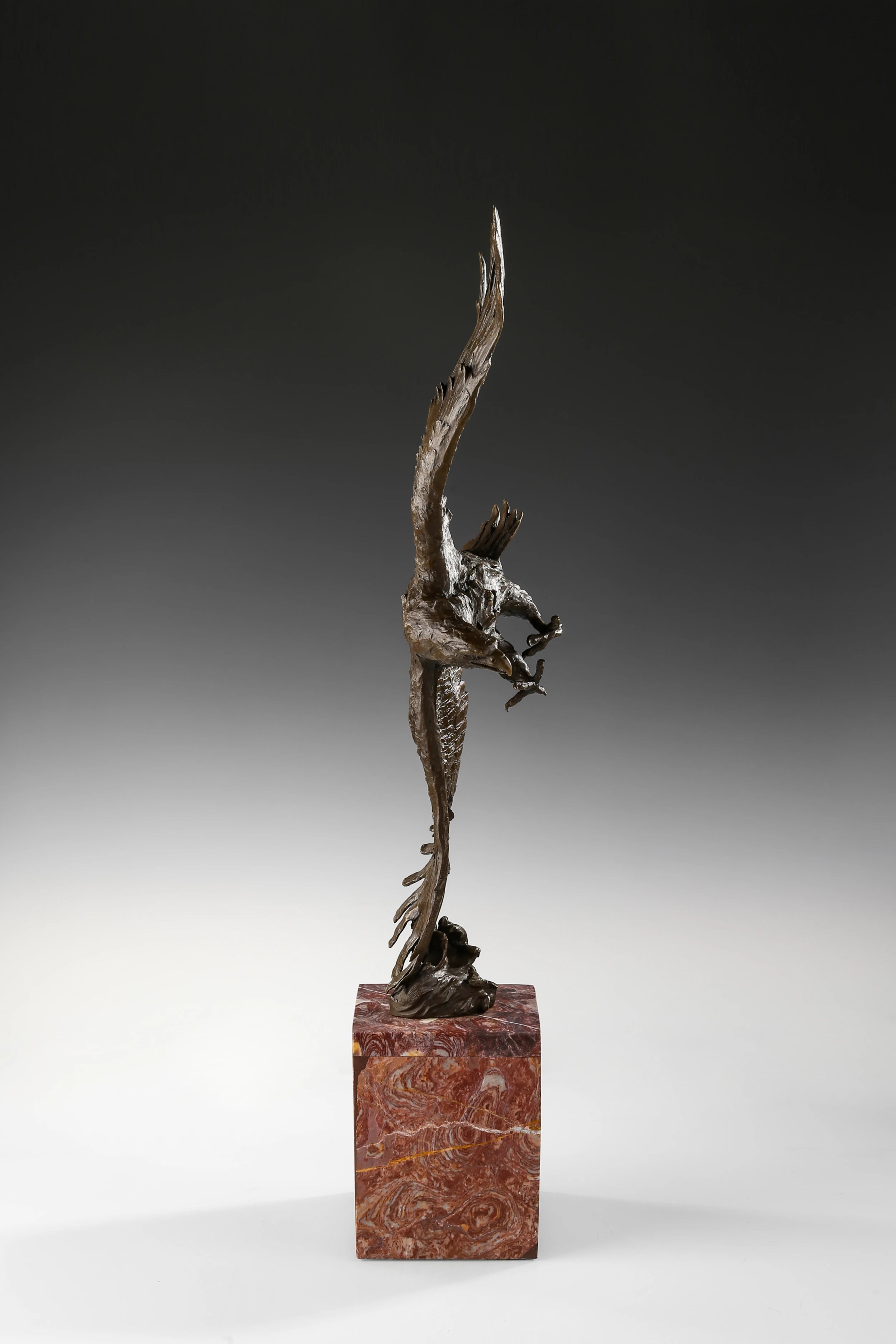 Bronze eagle sculpture over ocean waves with detailed feathers and marble base. Unique wildlife statue for home decor and collectors.