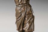 Rear-right view of female golfer bronze sculpture and flowing clothing detail