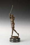 Close-up of the golfer's shoe and textured bronze ground above the marble base