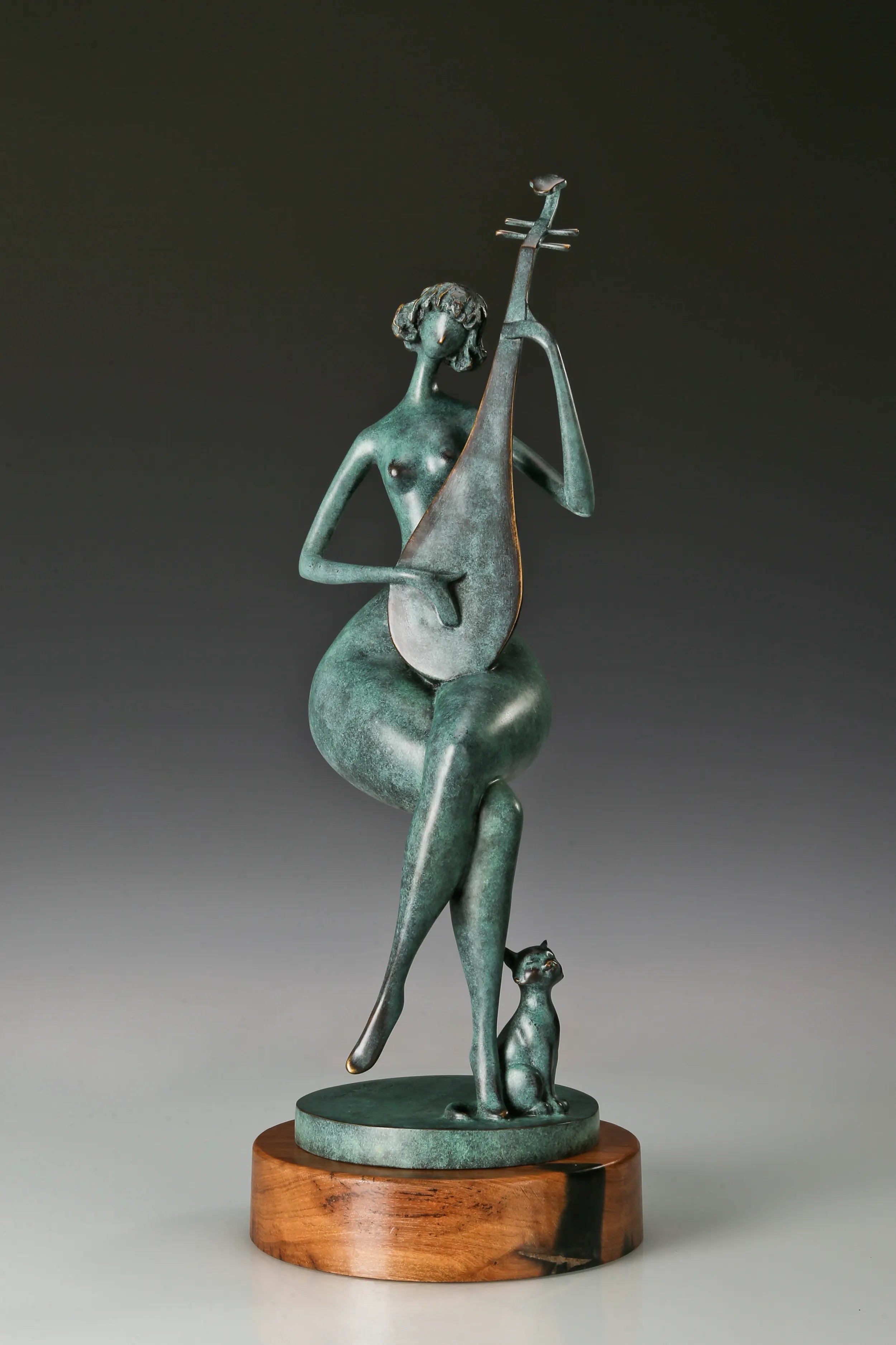 Angled front view of a seated woman playing the pipa with green patina and a round wooden base