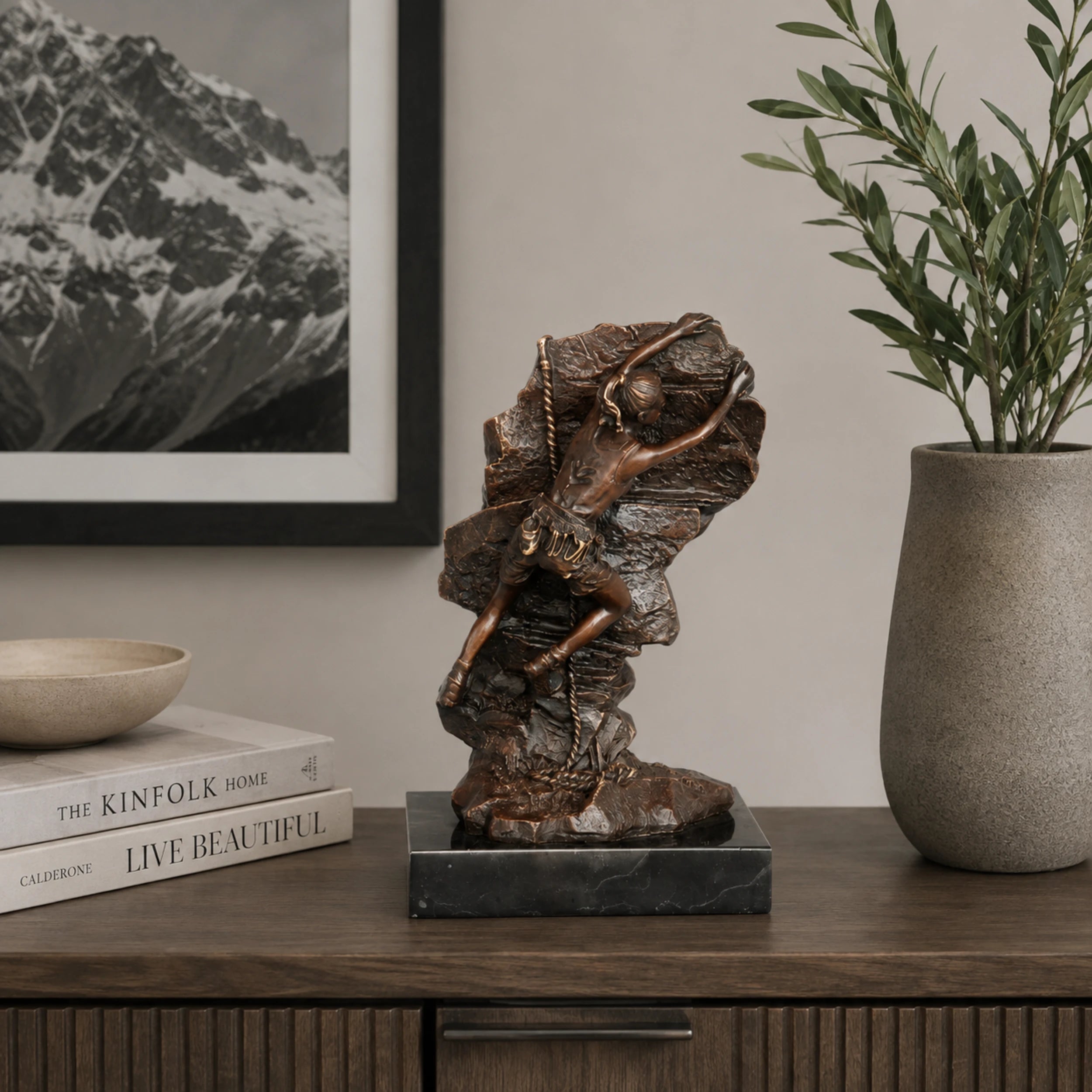 Alt:
Female rock climber bronze statue displayed as inspirational fitness decor in a modern home gym.