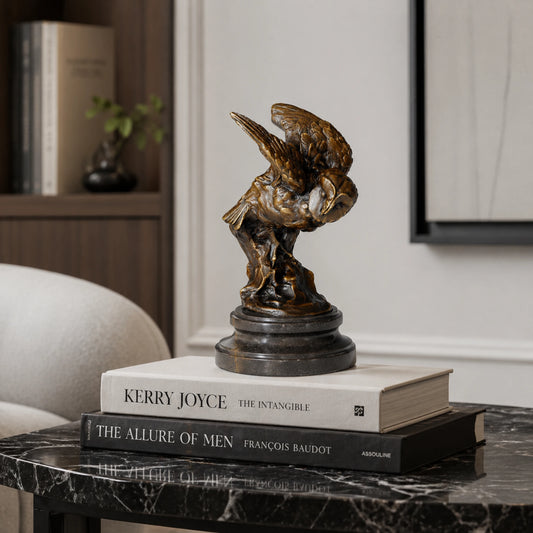 A bronze owl statue capturing the powerful moment of flight. Detailed feather textures and a black marble base make this wildlife statue perfect for home or office decor.