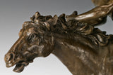 Close-up of galloping bronze horse head with detailed mane and expressive features
