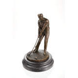 Bronze golfer statue putting with ball on marble base