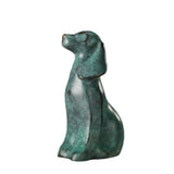 Handcrafted bronze seated dog sculpture with deep green patina and head raised upward