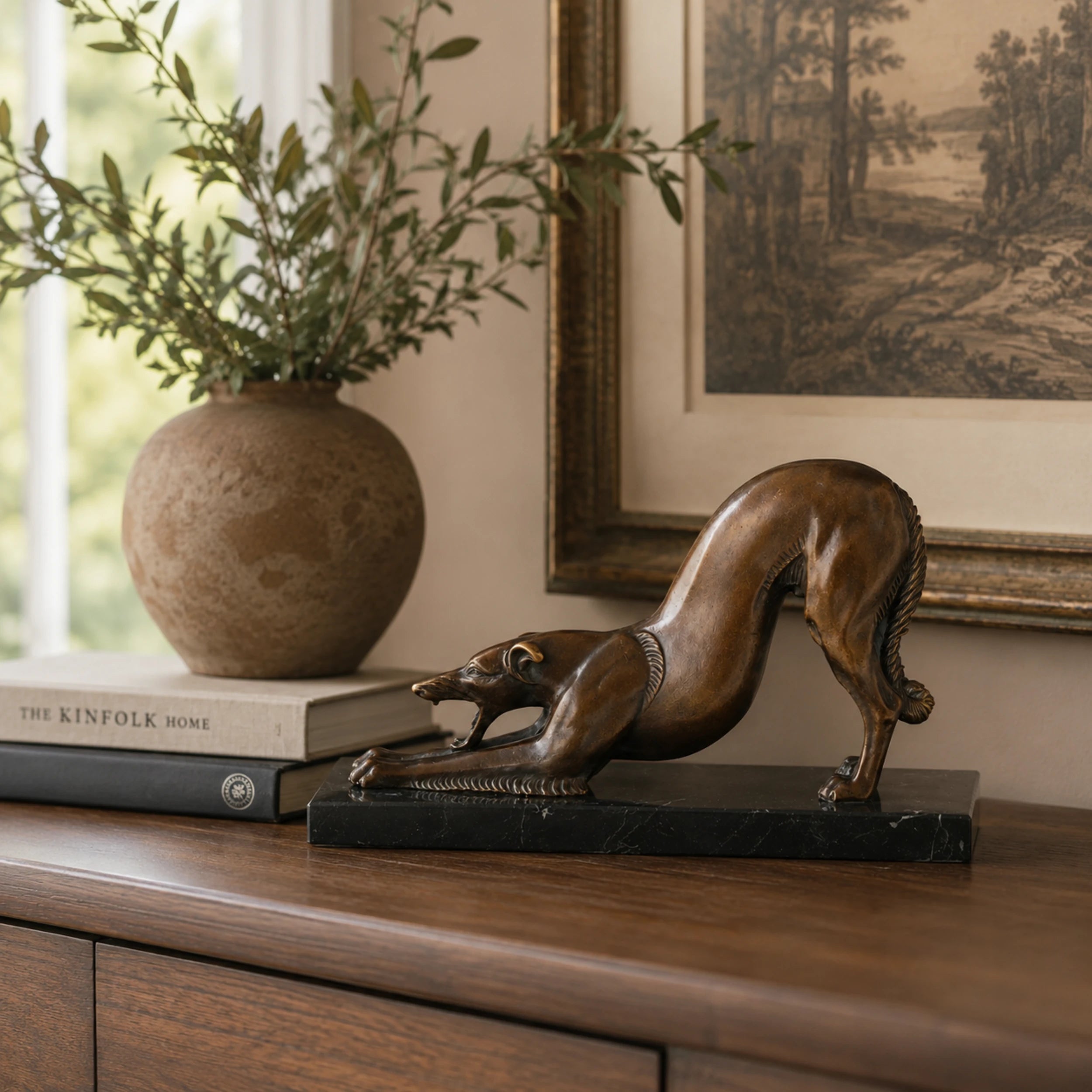Greyhound Stretching Bronze Sculpture displayed in a styled interior