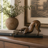 Greyhound Stretching Bronze Sculpture displayed in a styled interior