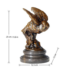 A bronze owl statue capturing the powerful moment of flight. Detailed feather textures and a black marble base make this wildlife statue perfect for home or office decor.