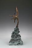 Bronze eagle sculpture with wings spread, capturing a powerful takeoff moment. A bold statue symbolizing strength, freedom, and ambition.