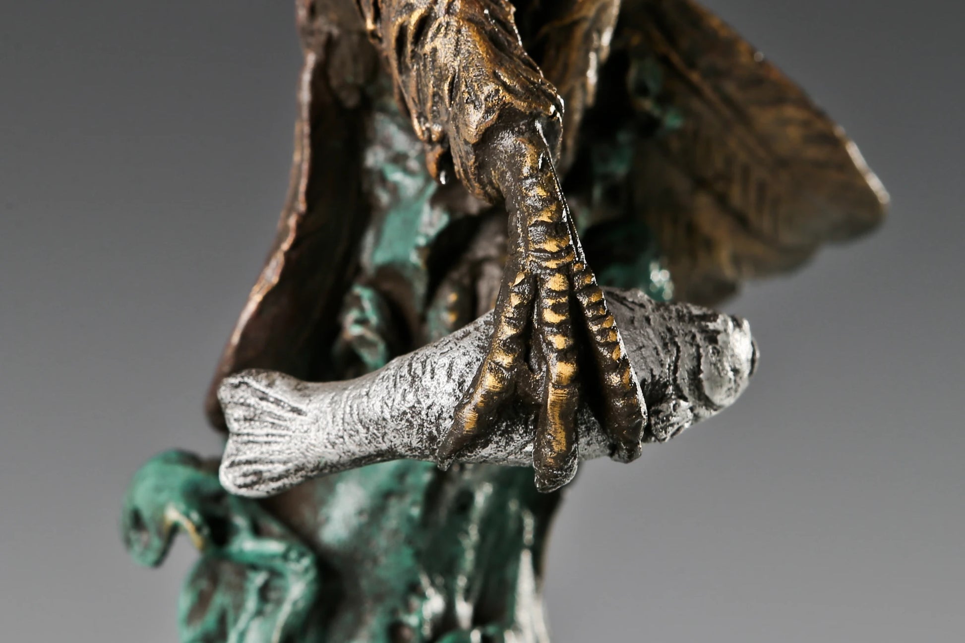 bronze eagle statue with spread wings on marble base
