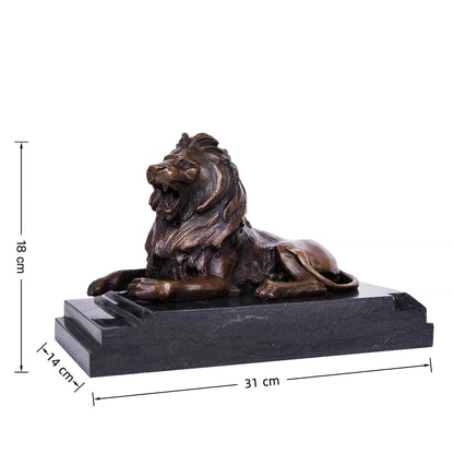 This is a powerful bronze lion sculpture, cast using the lost-wax method, depicting the animal in a reclining pose with its mouth open in a fierce roar. The sculpture features a rich, aged bronze patina that highlights the intricate, flowing details of its mane and the taut musculature of its body, conveying a sense of primal strength and authority. The lion’s head is raised, and its expression is intense, while its body rests in a relaxed yet alert posture, suggesting a moment of warning or dominance.