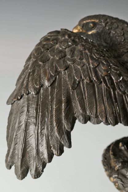 Elegant bronze eagle sculpture with ornate pedestal and detailed feathers. A refined statement piece symbolizing strength, control, and authority.