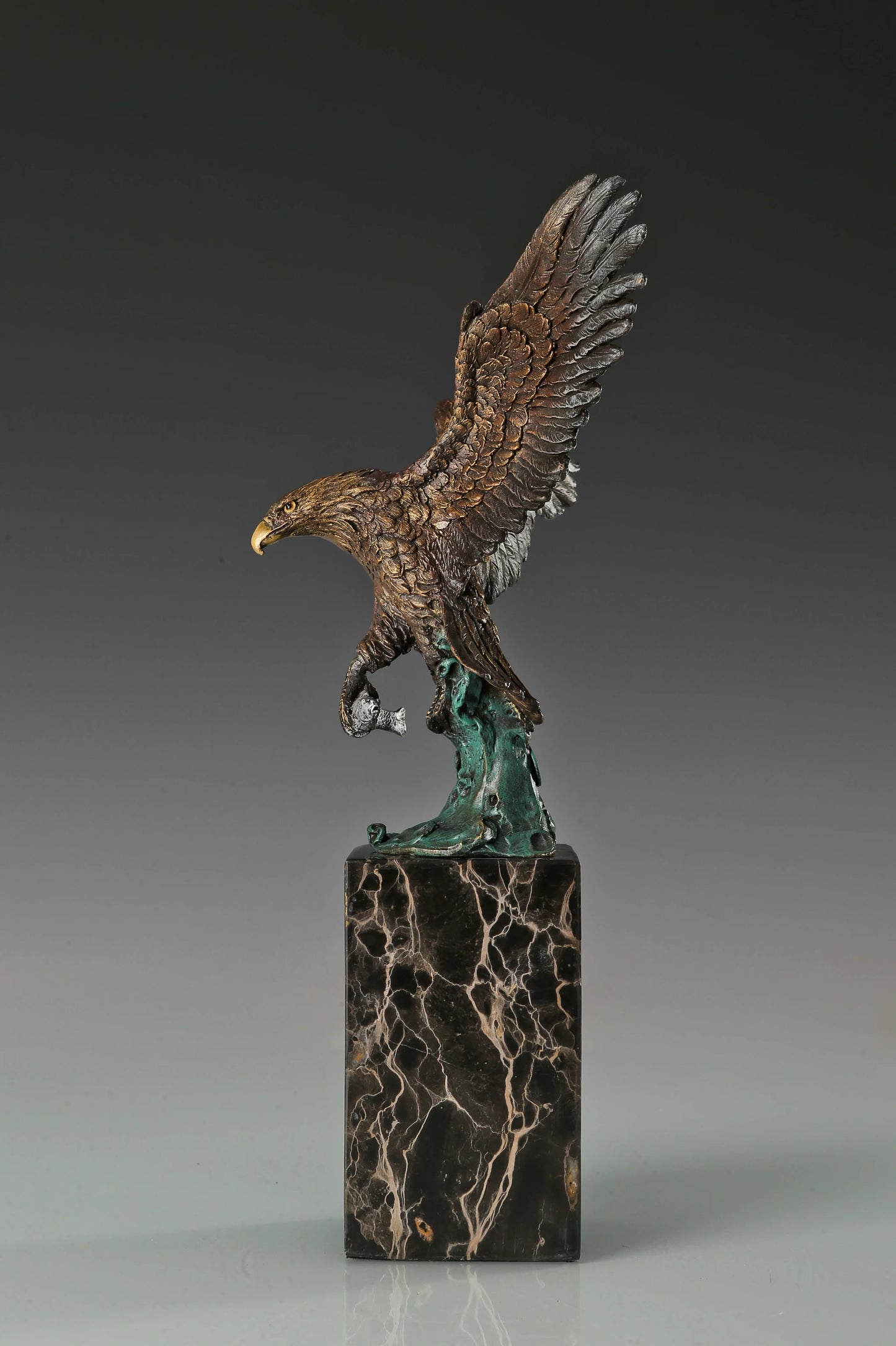 Handcrafted bronze eagle sculpture featuring spread wings and detailed feathers. Mounted on a marble base, this striking wildlife statue symbolizes strength, freedom, and prestige.