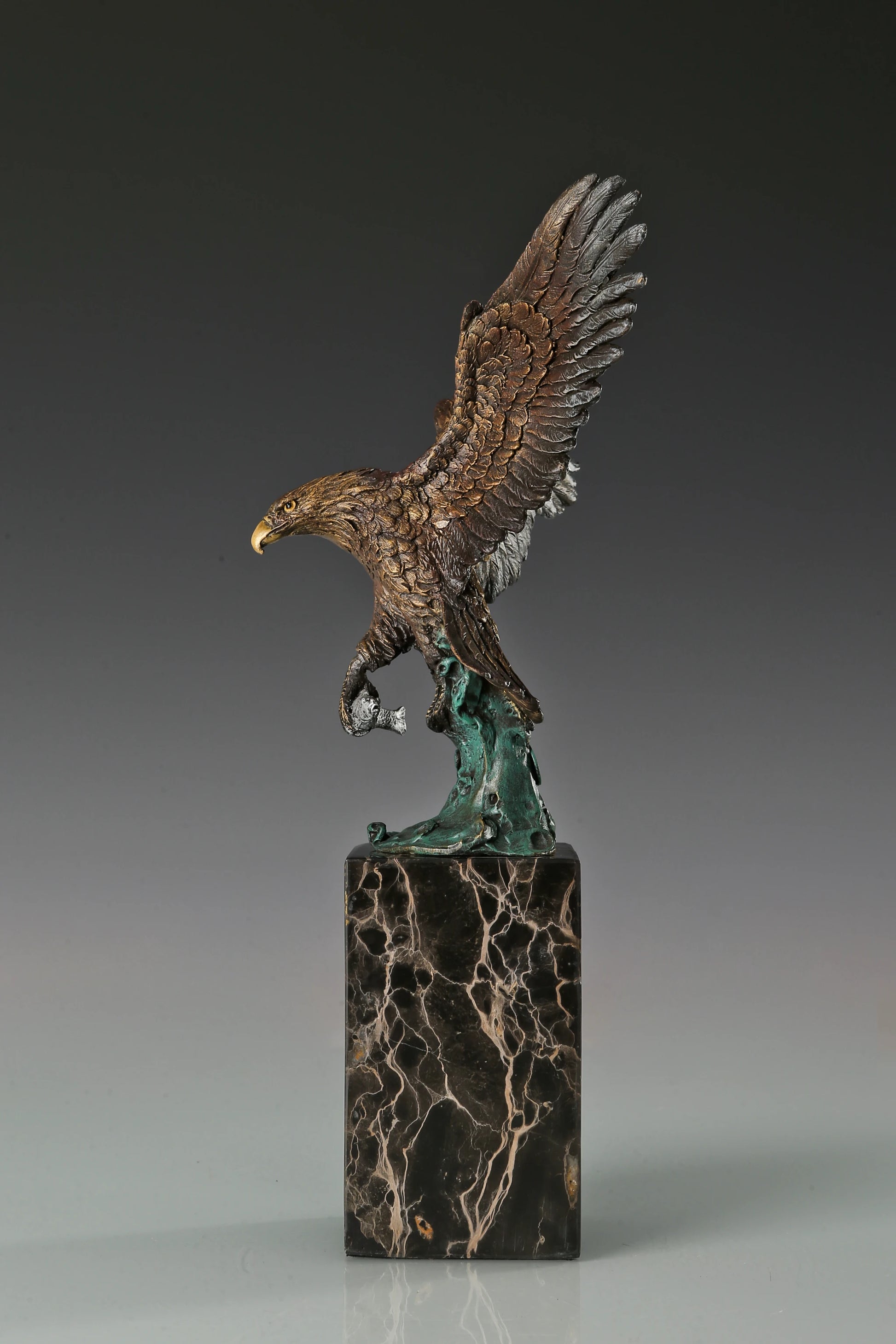 Handcrafted bronze eagle sculpture featuring spread wings and detailed feathers. Mounted on a marble base, this striking wildlife statue symbolizes strength, freedom, and prestige.