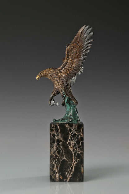 Handcrafted bronze eagle sculpture featuring spread wings and detailed feathers. Mounted on a marble base, this striking wildlife statue symbolizes strength, freedom, and prestige.