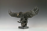 Majestic bald eagle bronze sculpture with wings spread and talons extended. A powerful wildlife statue symbolizing freedom, strength, and leadership.