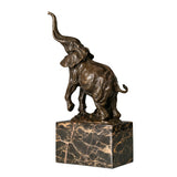 Playful elephant calf bronze sculpture with raised trunk and textured patina. A charming wildlife statue symbolizing joy, luck, and new beginnings.